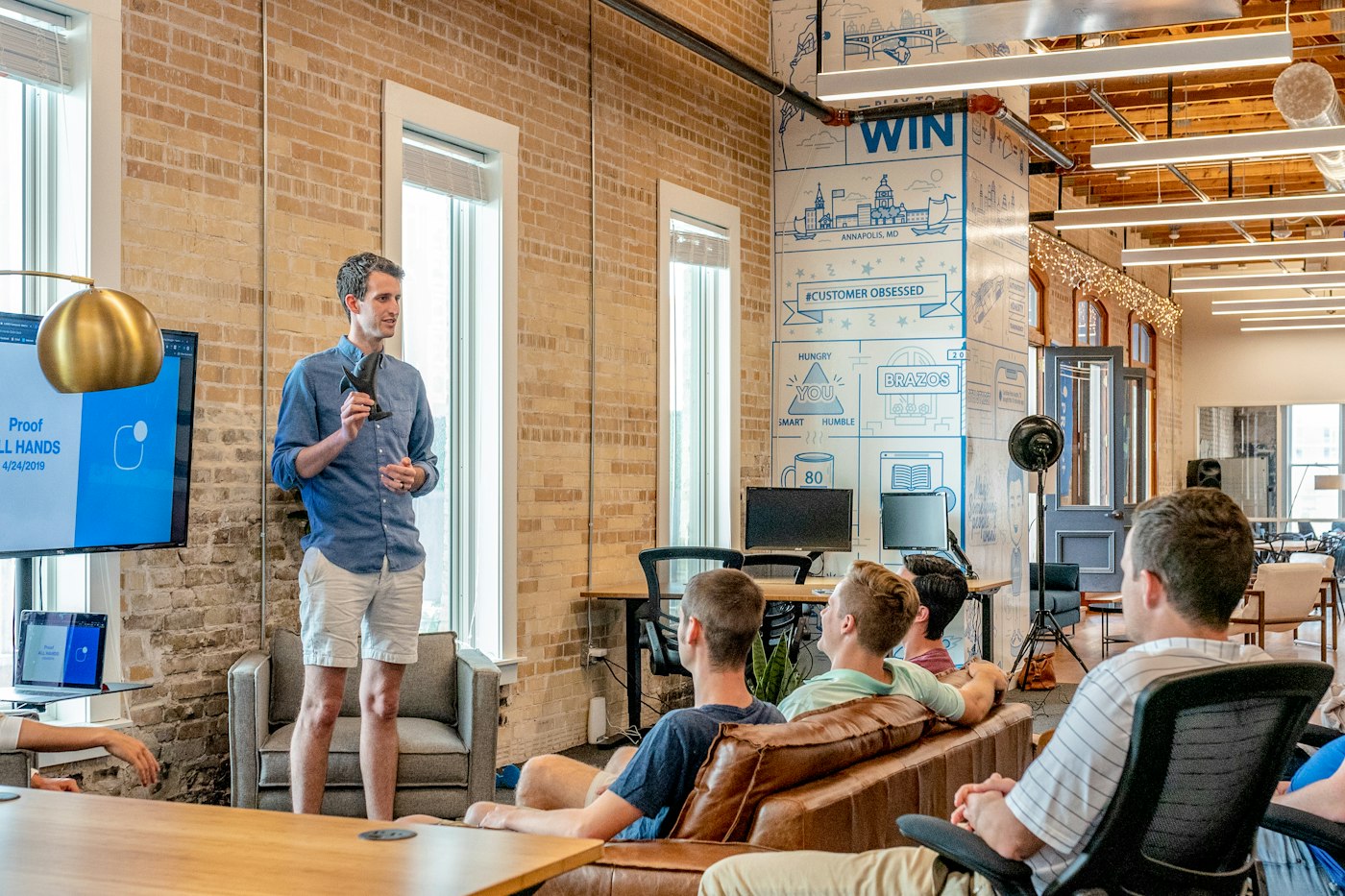 Founder presenting to a small team in a studio office